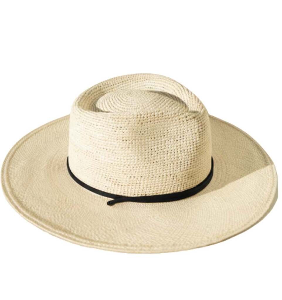 Wide-brim straw hat featuring a thin black decorative band, isolated on a white background for summer fashion.