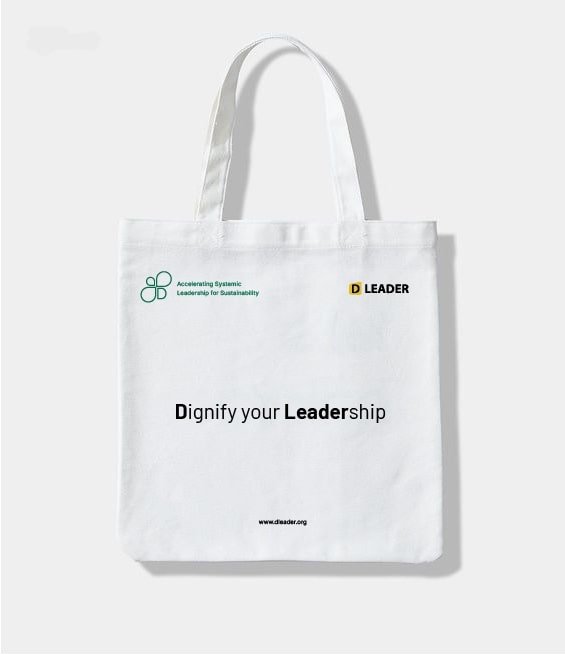 White cotton tote bag with a black 'Habitat Cultures' logo and a cotton flower on a wood table.