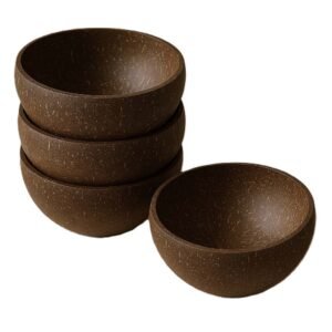Four eco-friendly coconut shell bowls, three stacked and one beside, on a white background.