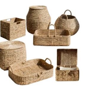 Assorted natural seagrass storage baskets, including lidded bins, trays, and hampers with handles.