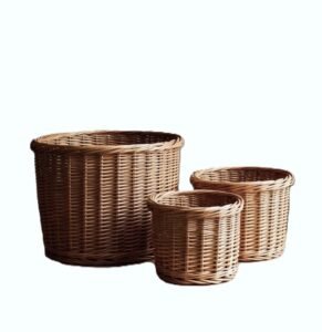 Three round woven willow wicker storage baskets in varying sizes, nested and grouped.
