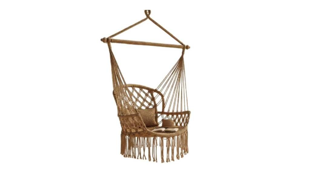 Macramé hammock chair with fringe and wooden spreader bar for indoor or outdoor lounging.